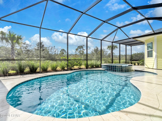 view of pool featuring a lanai and an in ground hot tub