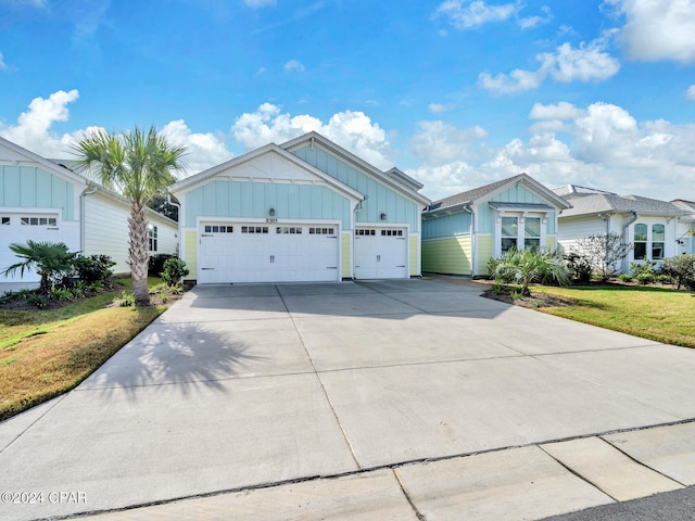 view of front of home featuring a garage and a front lawn