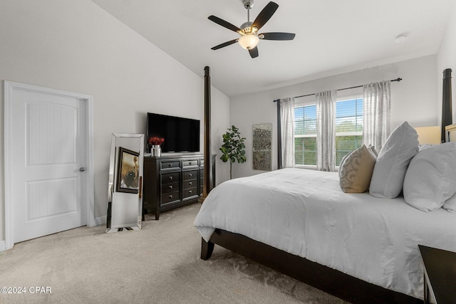 carpeted bedroom with ceiling fan and vaulted ceiling