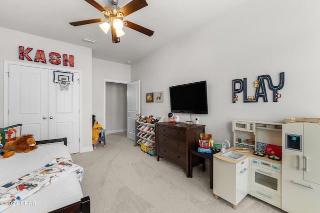 bedroom with a closet, light carpet, and ceiling fan