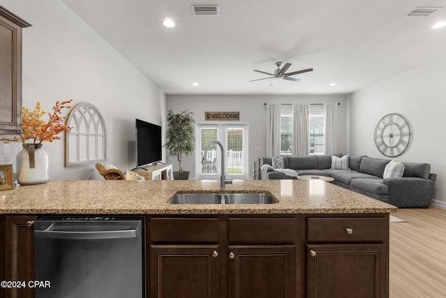 kitchen with light wood-type flooring, dark brown cabinetry, sink, stainless steel dishwasher, and ceiling fan