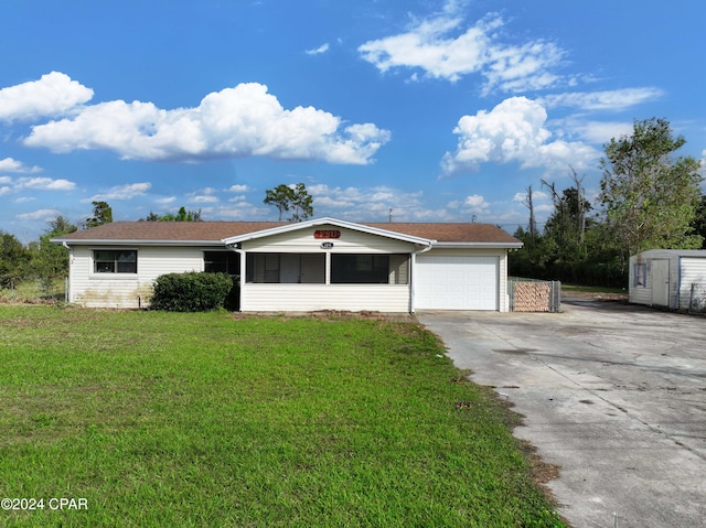 ranch-style house featuring a garage and a front lawn