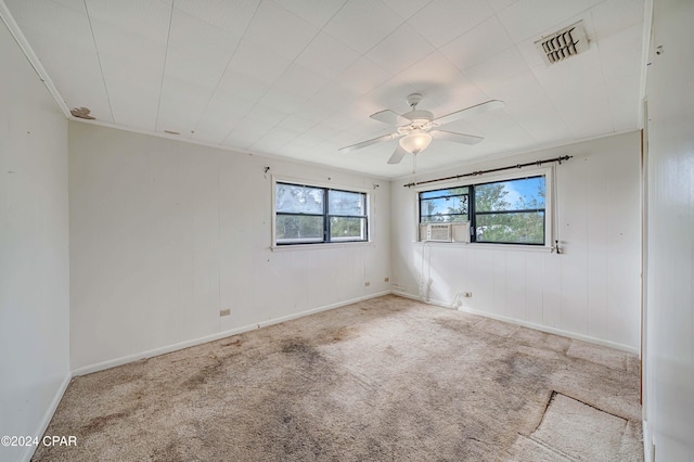 empty room with ceiling fan, light colored carpet, and cooling unit