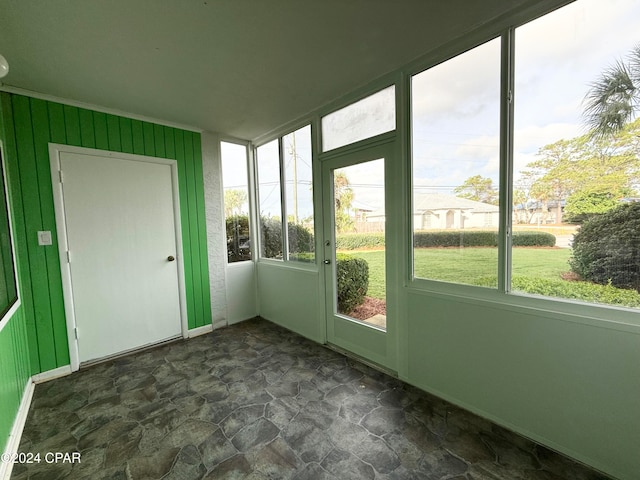 unfurnished sunroom featuring a healthy amount of sunlight