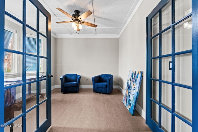 sitting room with ceiling fan, french doors, and ornamental molding