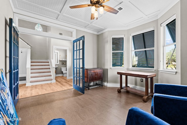 sitting room with light wood-type flooring, coffered ceiling, french doors, and ceiling fan