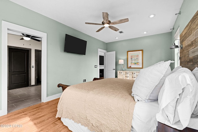 bedroom featuring hardwood / wood-style floors and ceiling fan