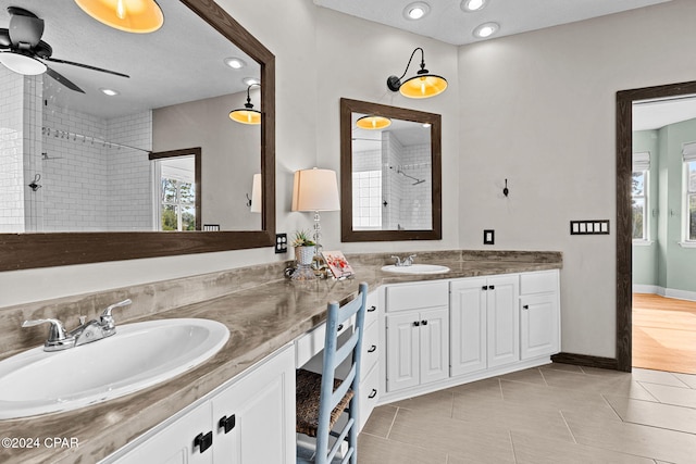 bathroom with vanity, tile patterned flooring, and a tile shower