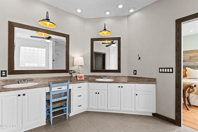 bathroom with hardwood / wood-style floors, vanity, ceiling fan, and a shower