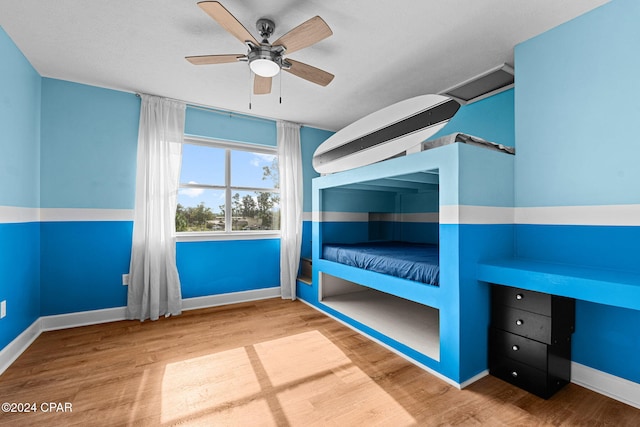 unfurnished bedroom featuring hardwood / wood-style floors and ceiling fan