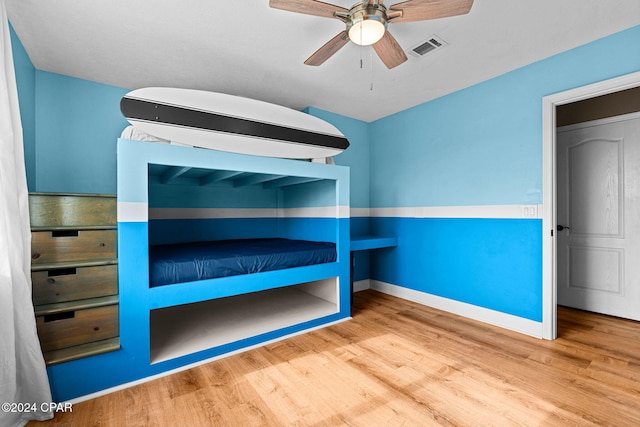 unfurnished bedroom featuring wood-type flooring and ceiling fan