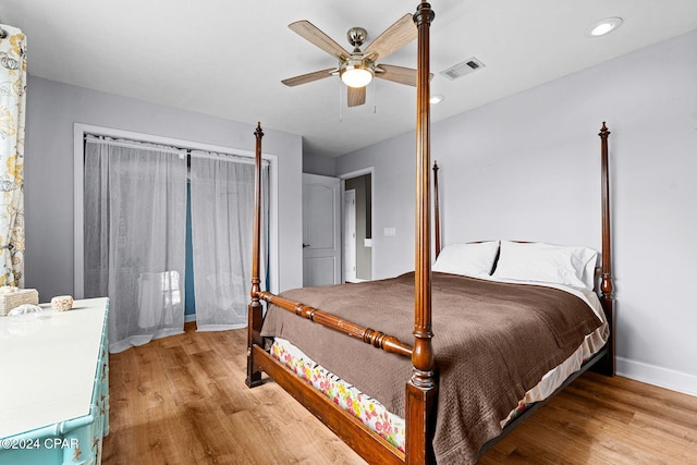 bedroom with light hardwood / wood-style floors and ceiling fan