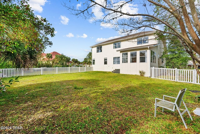 back of house with a yard