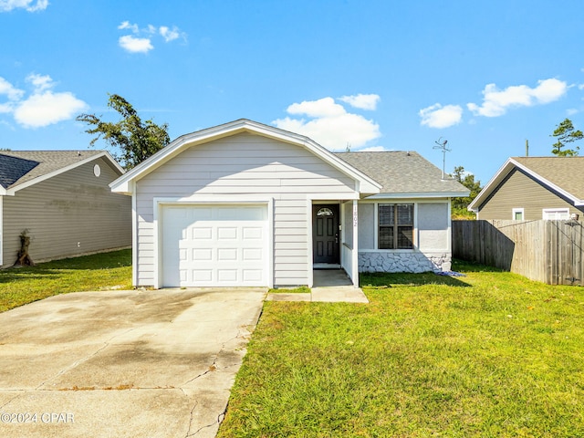 single story home featuring a garage and a front lawn