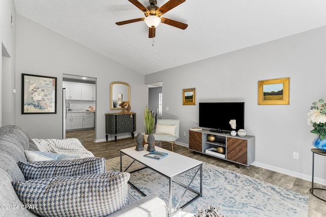 living room with hardwood / wood-style floors, ceiling fan, and lofted ceiling