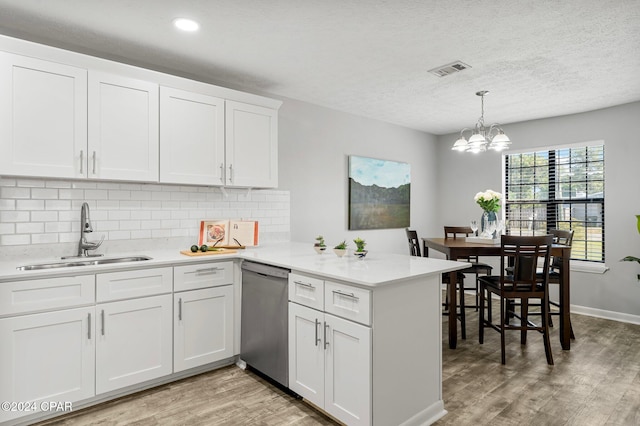 kitchen featuring white cabinetry, dishwasher, and sink