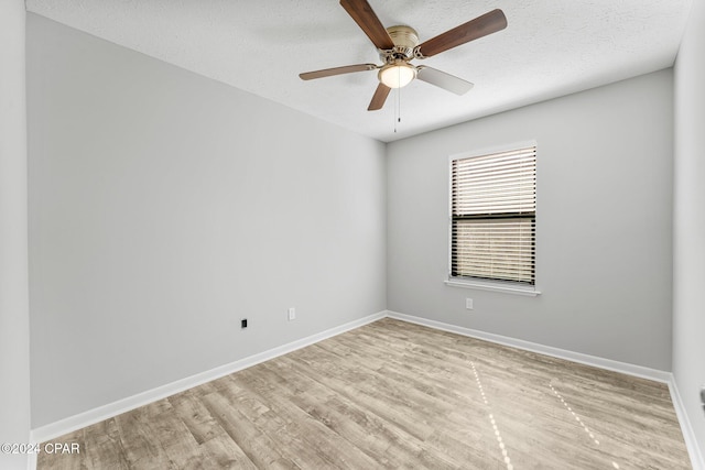 empty room with ceiling fan, a textured ceiling, and light hardwood / wood-style flooring