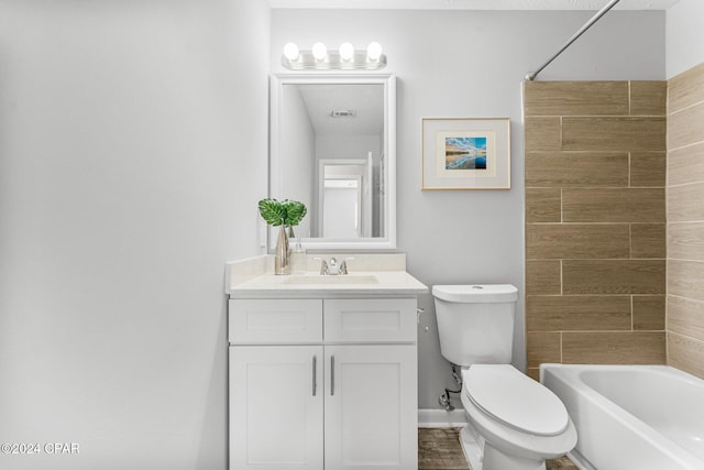 full bathroom featuring washtub / shower combination, vanity, and toilet