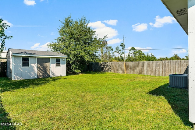 view of yard with a shed and central AC