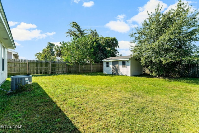 view of yard with an outbuilding and central air condition unit