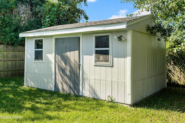 view of outdoor structure featuring a lawn