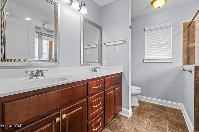 bathroom featuring walk in shower, vanity, a textured ceiling, tile patterned flooring, and toilet