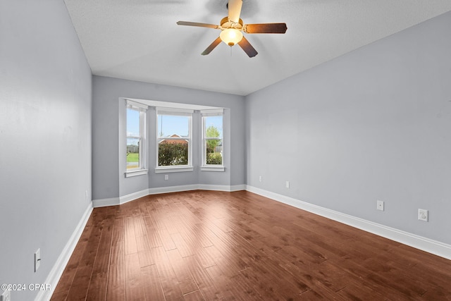 spare room featuring ceiling fan, wood-type flooring, a textured ceiling, and vaulted ceiling