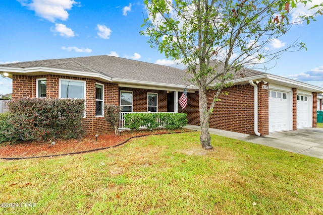 ranch-style house with covered porch, a front yard, and a garage