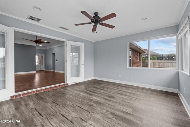 empty room featuring ceiling fan, french doors, crown molding, wood-type flooring, and a textured ceiling