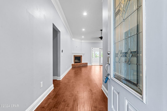 hall with hardwood / wood-style floors and crown molding