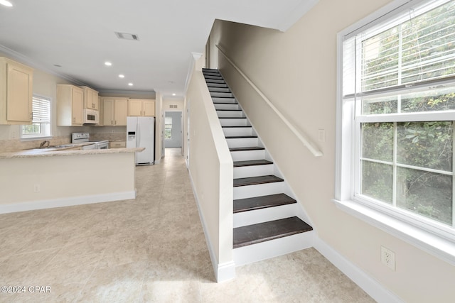 staircase featuring tile patterned flooring and crown molding