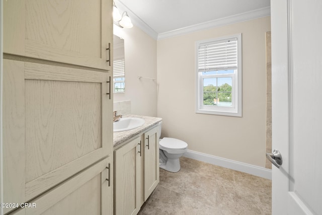 bathroom featuring vanity, toilet, and ornamental molding