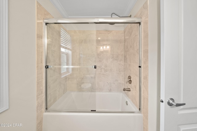 bathroom featuring shower / bath combination with glass door and crown molding