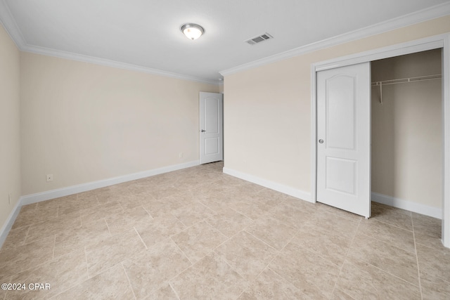 unfurnished bedroom featuring ornamental molding and a closet