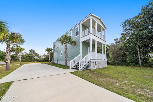 view of front of house with a front yard and a balcony