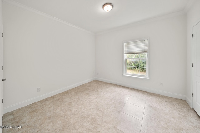 tiled empty room featuring crown molding