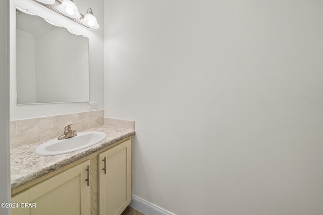 bathroom featuring vanity and decorative backsplash