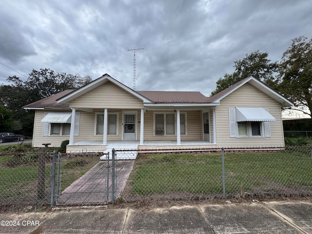 view of front of home featuring a front yard and a porch