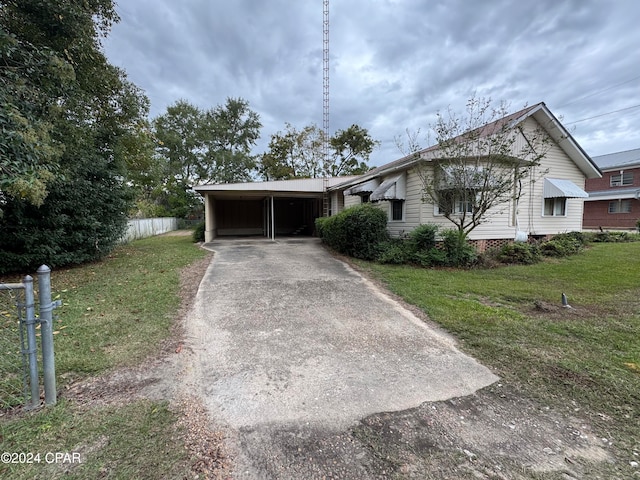 ranch-style house with a front yard and a carport