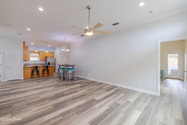 kitchen featuring light hardwood / wood-style floors, sink, appliances with stainless steel finishes, tasteful backsplash, and pendant lighting