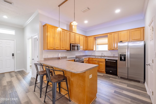 kitchen featuring sink, light wood-type flooring, appliances with stainless steel finishes, and tasteful backsplash