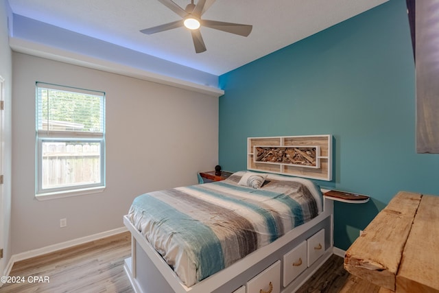 bedroom with ceiling fan, dark hardwood / wood-style floors, and a closet