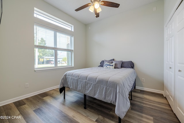 bedroom with dark hardwood / wood-style flooring, ceiling fan, and ensuite bath