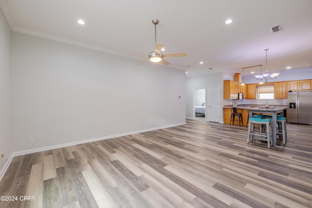 kitchen featuring crown molding, stainless steel appliances, hanging light fixtures, dark wood-type flooring, and kitchen peninsula