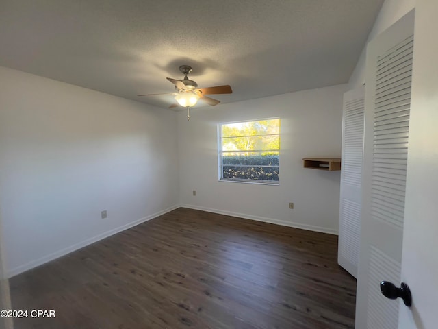 unfurnished bedroom featuring ceiling fan, dark hardwood / wood-style flooring, and a textured ceiling