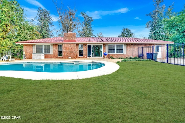 back of property featuring a fenced in pool and a yard