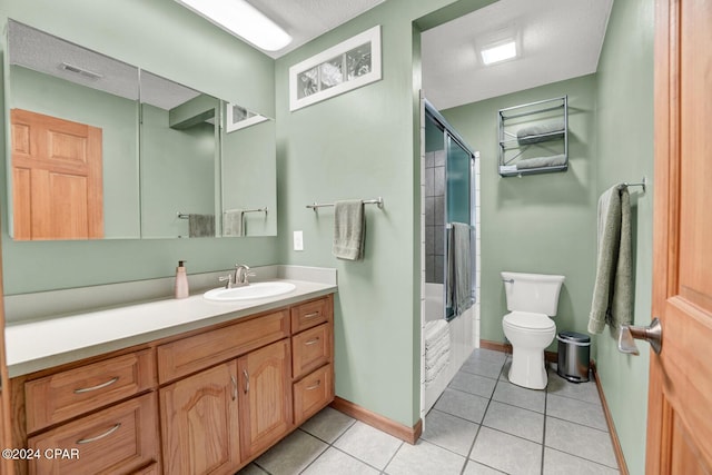 full bathroom with vanity, bath / shower combo with glass door, tile patterned floors, and toilet