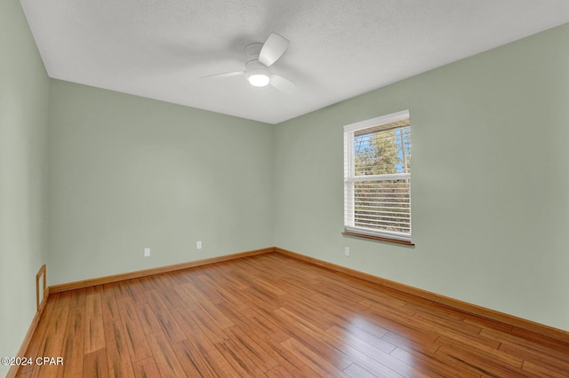 spare room featuring hardwood / wood-style flooring, a textured ceiling, and ceiling fan