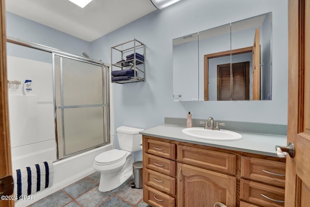 full bathroom with vanity, shower / bath combination with glass door, and toilet