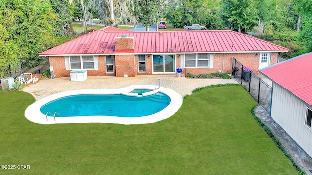 back of house with a fenced in pool and a yard